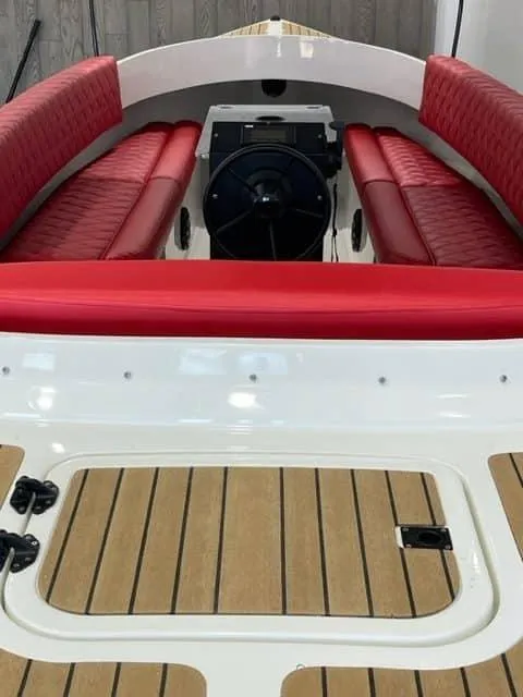 Slide: The Image of 2024 Vision Marine Technologies Fantail 217 boat with red seating and wooden deck. - 5