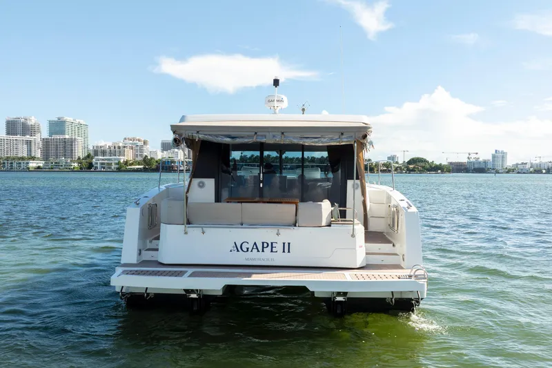 Slide: The Image of 2023 Fountaine Pajot MY4.S yacht on water, city skyline in background. - 14