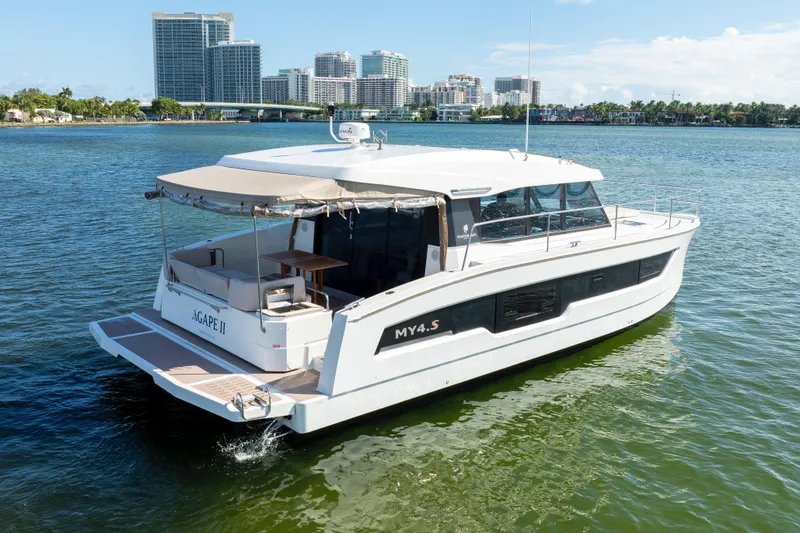 Slide: The Image of 2023 Fountaine Pajot MY4.S yacht on water with city skyline in background. - 15