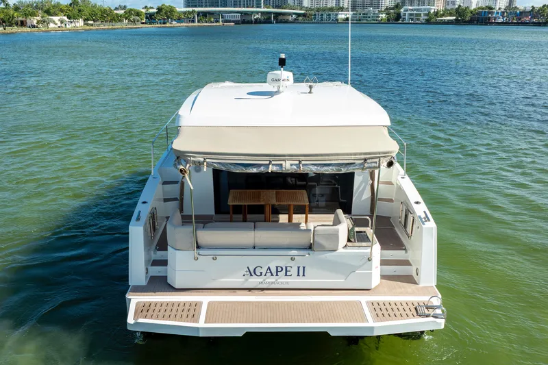 Slide: The Image of 2023 Fountaine Pajot MY4.S yacht on water, rear view with seating area. - 16