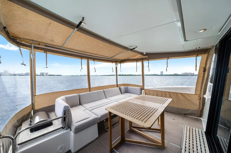 Slide: The Image of 2023 Fountaine Pajot MY4.S yacht interior with seating and table, overlooking water. - 21