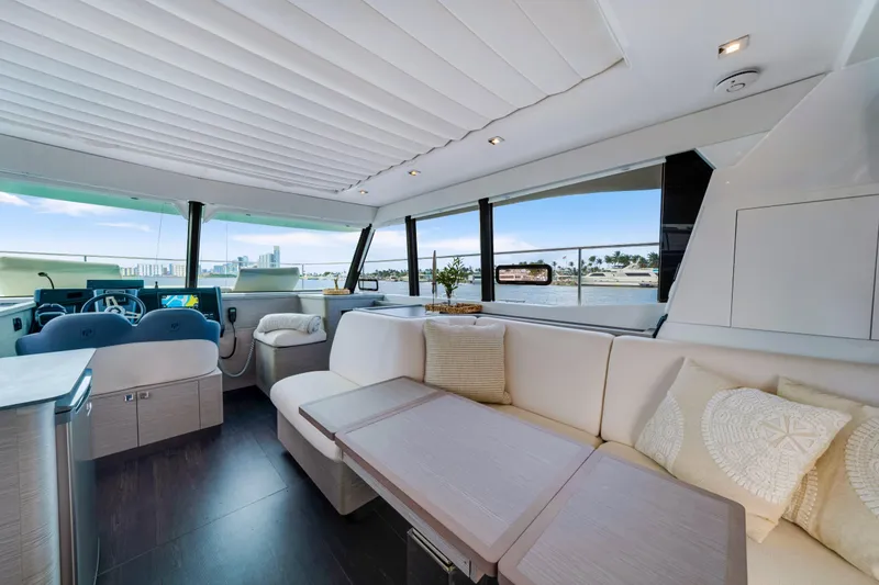 Slide: The Image of Luxurious interior of 2023 Fountaine Pajot MY4.S yacht with elegant seating and panoramic windows. - 28