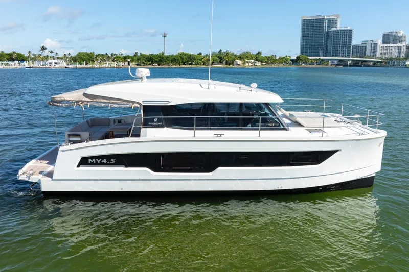 Slide: The Image of 2023 Fountaine Pajot MY4.S yacht on calm water, modern design, cityscape background. - 3