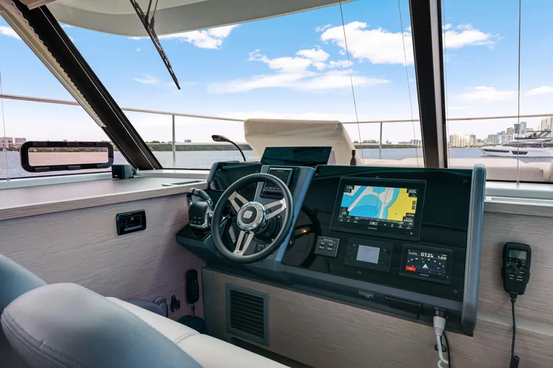 Slide: The Image of 2023 Fountaine Pajot MY4.S yacht helm with navigation screens and steering wheel. - 31
