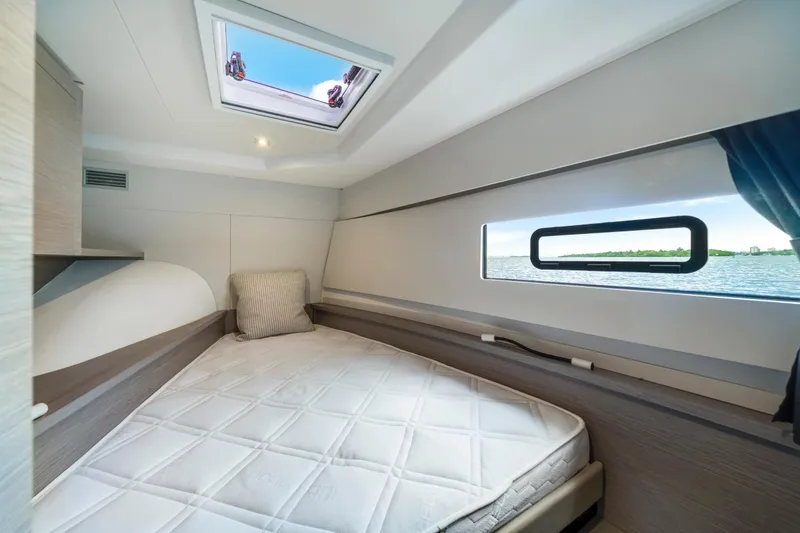 Slide: The Image of 2023 Fountaine Pajot MY4.S cabin interior with bed, window view, and skylight. - 38