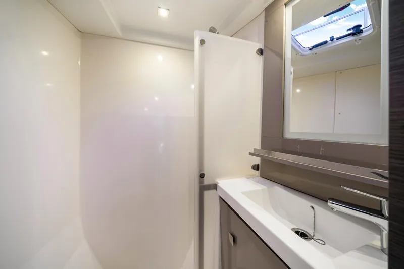 Slide: The Image of Modern bathroom interior of 2023 Fountaine Pajot MY4.S yacht, featuring sleek sink and mirror. - 40