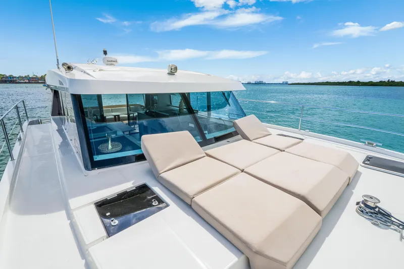 Slide: The Image of 2023 Fountaine Pajot MY4.S yacht with sun loungers on deck, ocean view. - 8