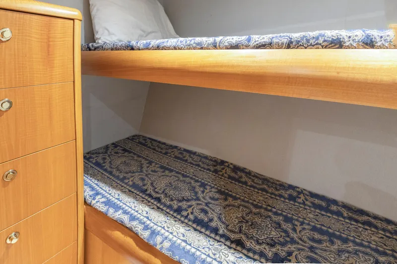 Slide: The Image of Engine room of a 2005 Weaver 61 yacht, showcasing complex machinery and piping. - 21