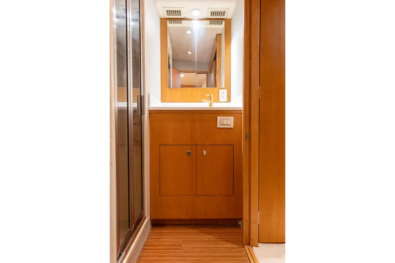 Slide: The Image of Interior of 2005 Weaver 61 yacht with wooden stairs and potted plant. - 26