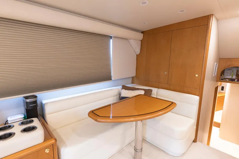 Slide: The Image of Luxurious Weaver 61 yacht interior with cozy dining area, wooden table, and plush seating, 2005 model. - 36