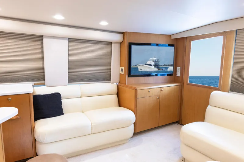Slide: The Image of Luxurious Weaver 61 yacht interior, featuring cream leather seating and a flat-screen TV, 2005 model. - 37