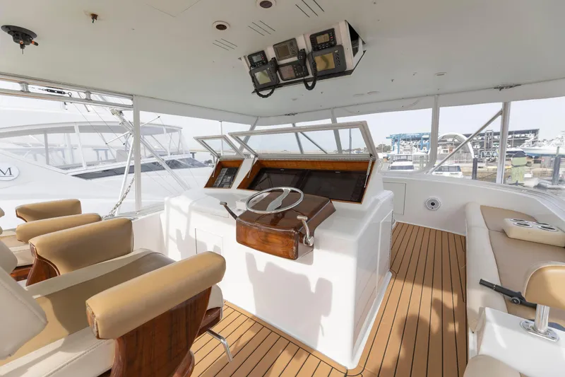 Slide: The Image of A 2005 Weaver 61 yacht cruising on the water with fishing rods. - 4