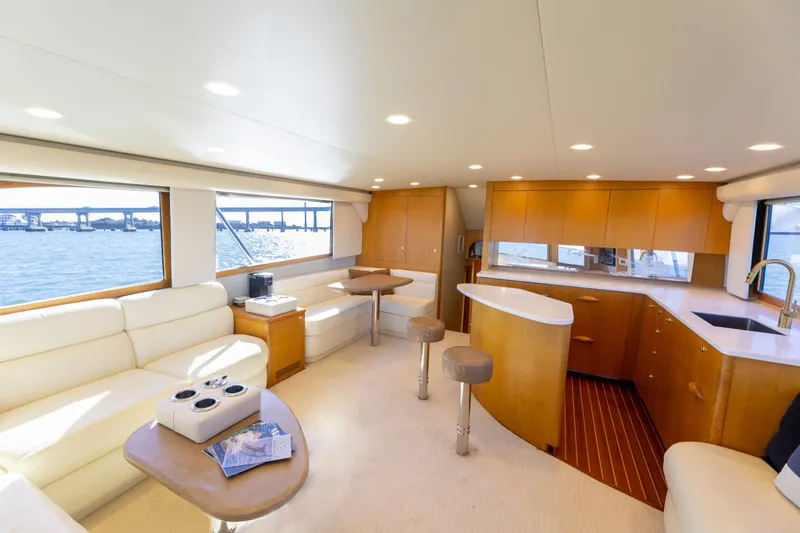 Slide: The Image of Luxurious Weaver 61 yacht interior, 2005 model, featuring elegant seating and modern kitchen with ocean view. - 40