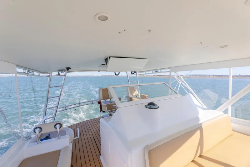 Slide: The Image of Flybridge of 2005 Weaver 61 yacht with seating, ocean view, and clear skies. - 42