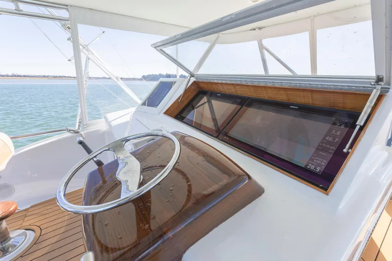 Slide: The Image of Helm of 2005 Weaver 61 yacht with wooden dashboard and modern navigation display. - 45