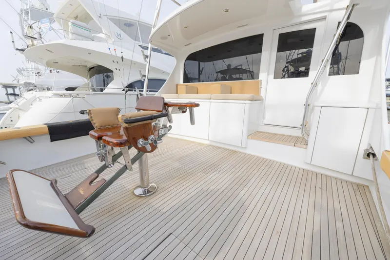 Slide: The Image of Luxurious 2005 Weaver 61 yacht deck with fishing chair and seating area. - 51