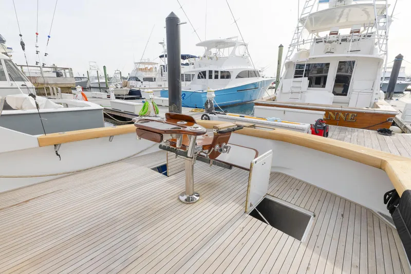 Slide: The Image of Luxury Weaver 61 yacht deck, 2005 model, docked at marina with fishing equipment. - 54