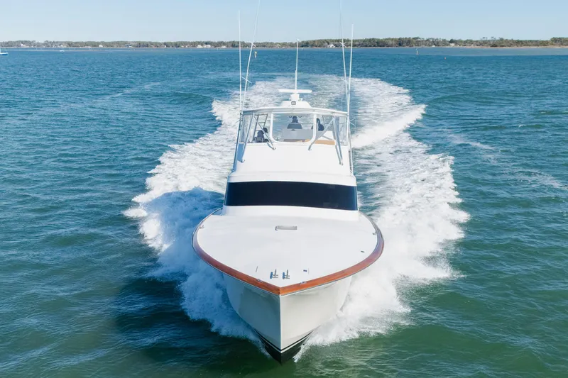 Slide: The Image of Weaver 61 yacht cruising on open water, 2005 model, creating a wake. - 57