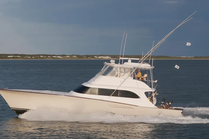 Slide: The Image of Luxury Weaver 61 yacht cruising on open water, 2005 model, with fishing gear visible. - 60