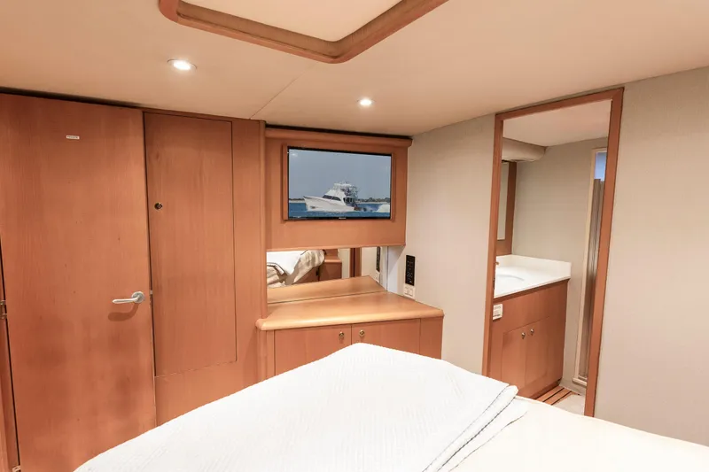 Slide: The Image of Luxurious cabin interior of 2005 Weaver 61 yacht with wooden finishes and modern amenities. - 62