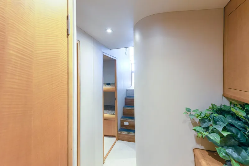 Slide: The Image of Interior hallway of 2005 Weaver 61 yacht with wooden accents and potted plant. - 64