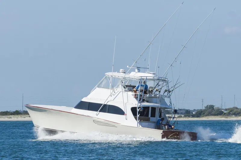 Slide: The Image of Sportfishing boat Weaver 61, 2005 model, cruising on open water. - 66