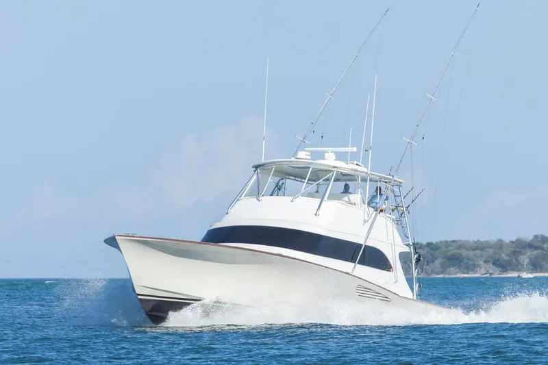 Slide: The Image of Weaver 61 yacht from 2005 cruising on open water, clear sky background. - 67