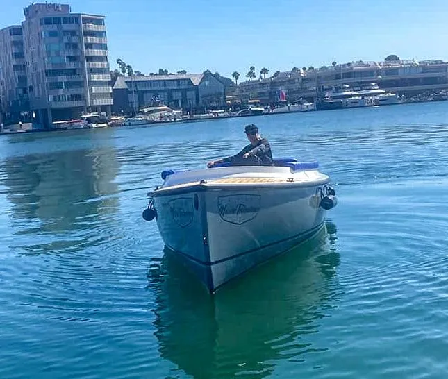 Slide: The Image of 2023 Vision Marine Technologies Fantail 217 boat on calm water near urban buildings. - 2
