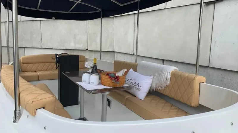 Slide: The Image of 2023 Vision Marine Technologies Fantail 217 boat interior with seating and table setup. - 2