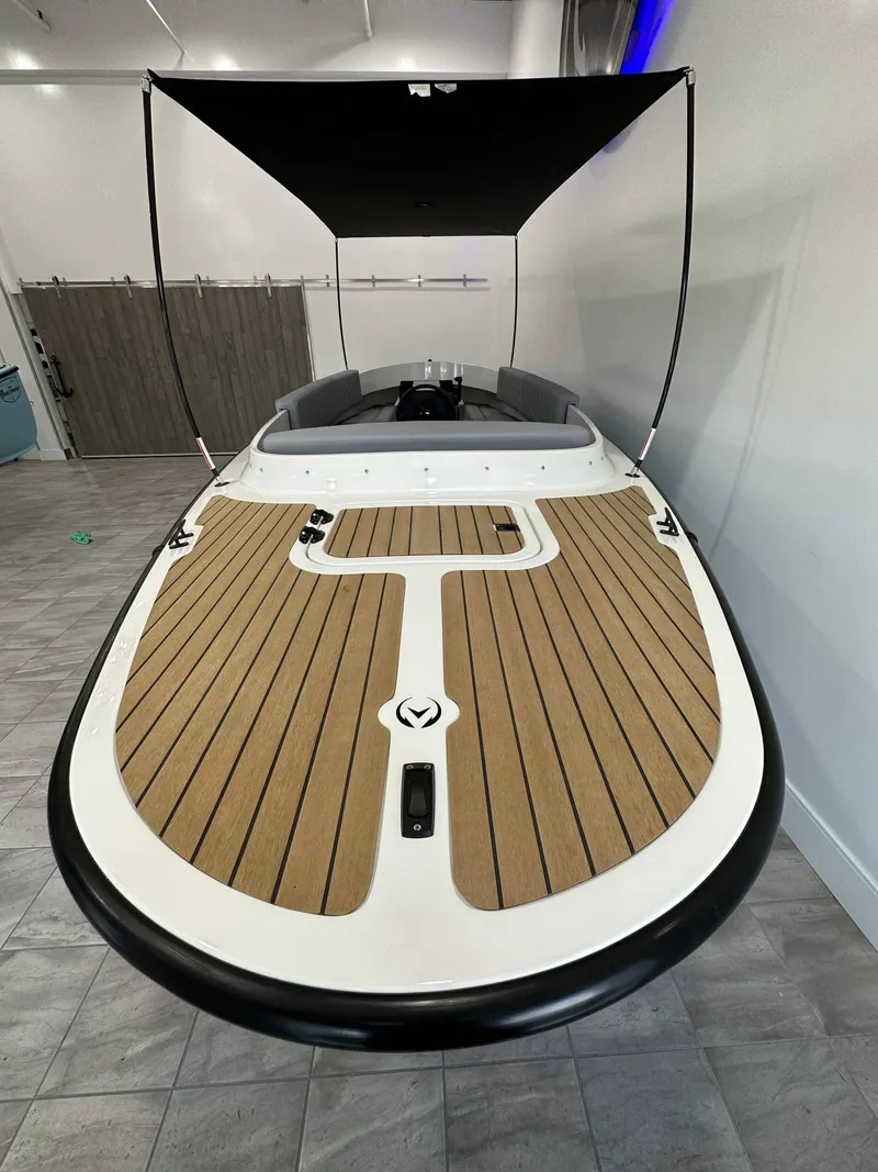 Slide: The Image of 2023 Vision Marine Technologies Fantail 217 boat with sleek wooden deck and canopy. - 4