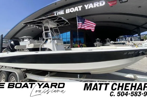 The Image of 2007 Triton 240 LTS boat on trailer at The Boat Yard, Louisiana, with American flag. - 1