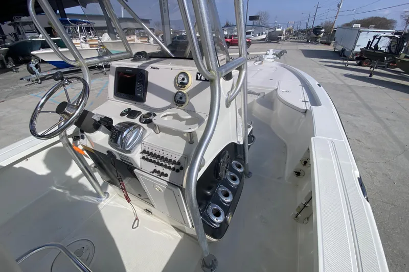 Slide: The Image of 2007 Triton 240 LTS boat interior with steering console and navigation equipment. - 12