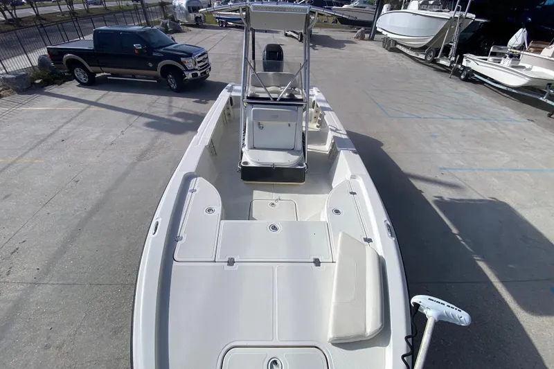 Slide: The Image of 2007 Triton 240 LTS boat in a marina, featuring spacious deck and center console. - 13