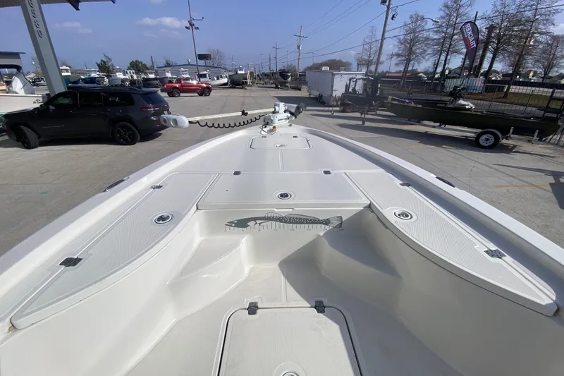 Slide: The Image of 2007 Triton 240 LTS boat deck view at a marina with vehicles in background. - 15