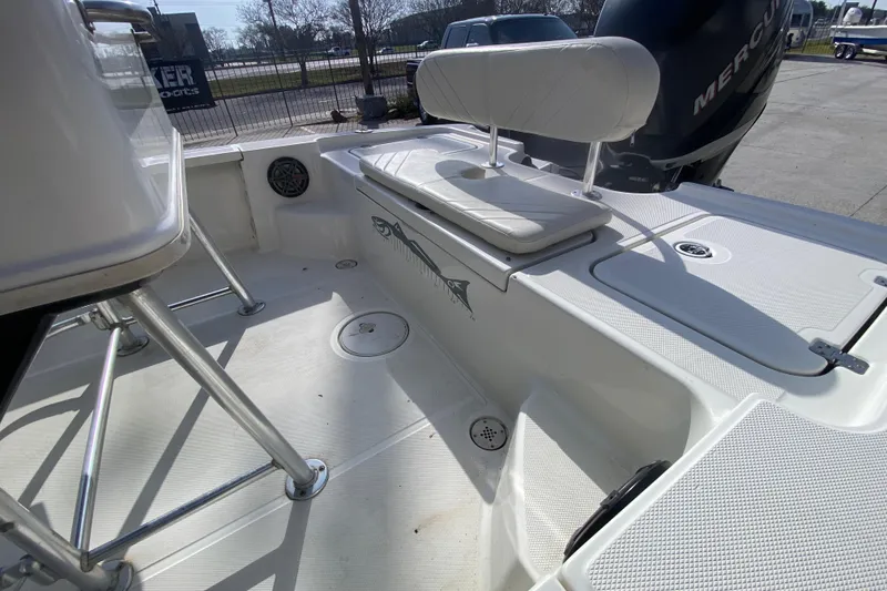 Slide: The Image of 2007 Triton 240 LTS boat interior with seating and Mercury engine. - 20
