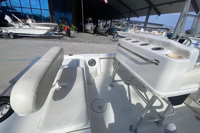 Slide: The Image of 2007 Triton 240 LTS boat interior with seating and rod holders in a showroom. - 21