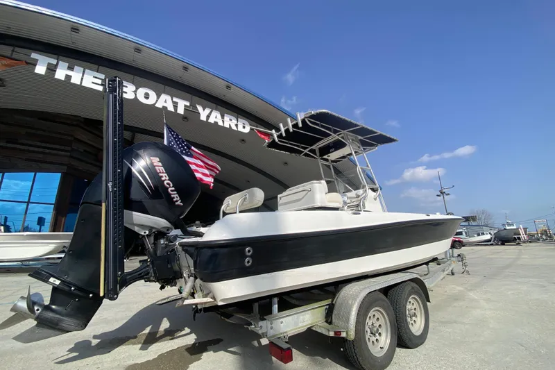 Slide: The Image of 2007 Triton 240 LTS boat on trailer at The Boat Yard, featuring Mercury engine. - 3