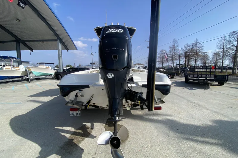 Slide: The Image of 2007 Triton 240 LTS boat with powerful 250 horsepower engine, parked outdoors. - 4