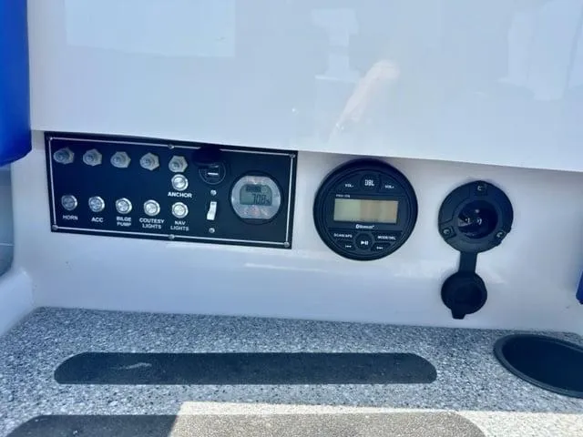 Slide: The Image of Control panel of 2023 Vision Marine Technologies Fantail 217 boat with switches and gauges. - 6