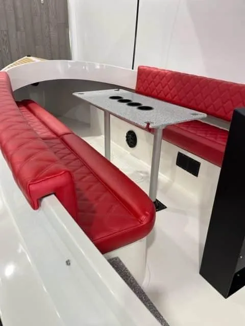 Slide: The Image of 2023 Vision Marine Technologies Fantail 217 interior with red seating and a central table. - 2