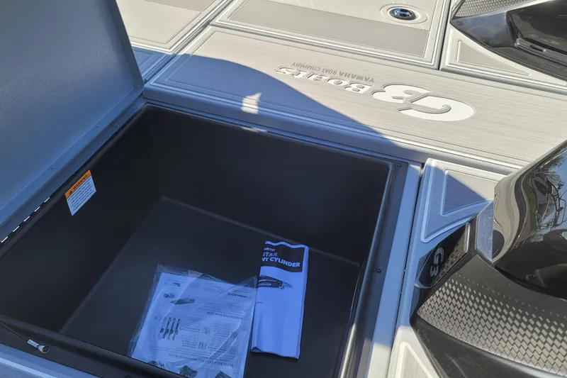 Slide: The Image of Open storage compartment on 2026 G3 Sportsman 1810 SE boat deck. - 15