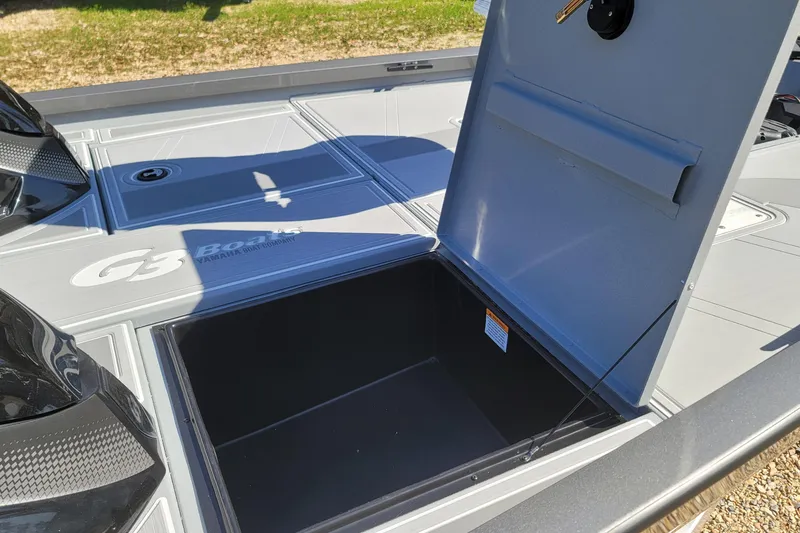 Slide: The Image of Open storage compartment on 2026 G3 Sportsman 1810 SE boat deck. - 16