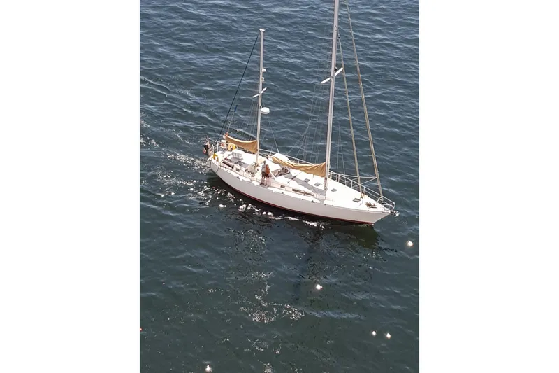 The Image of 1979 Amel Mango sailboat cruising on open water, viewed from above. - 0
