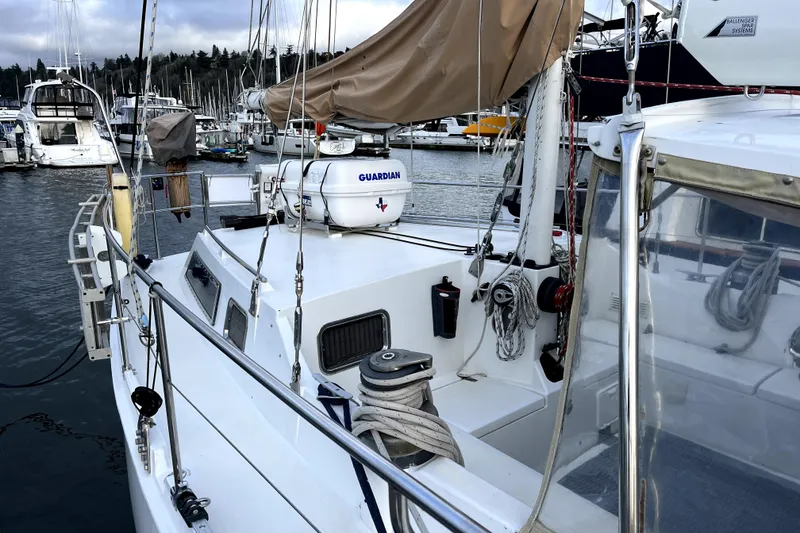 Slide: The Image of 1979 Amel Mango sailboat docked in marina, featuring deck and rigging details. - 15