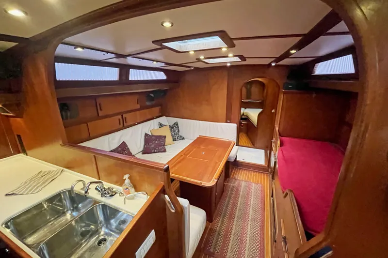 Slide: The Image of Interior of 1979 Amel Mango sailboat with cozy seating and wooden finishes. - 24