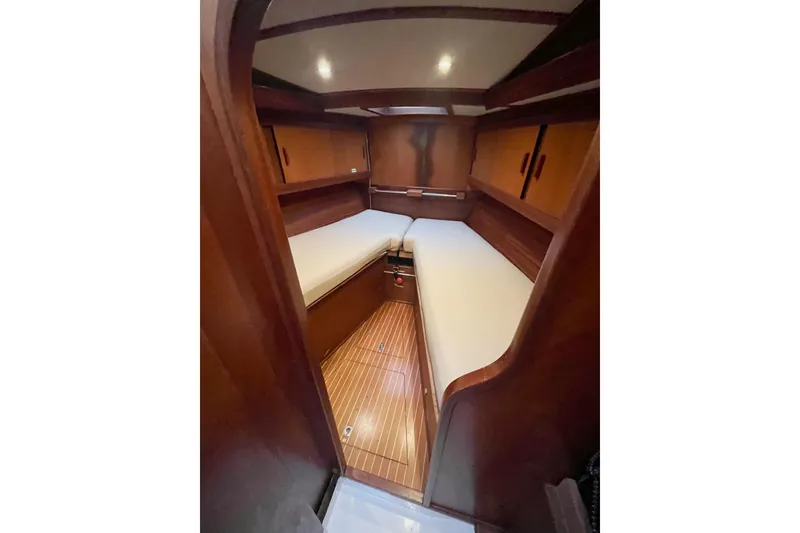 Slide: The Image of 1979 Amel Mango yacht cabin with wooden interior and cozy sleeping area. - 25