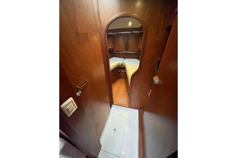 Slide: The Image of 1979 Amel Mango yacht interior with wooden finish and cozy cabin space. - 26