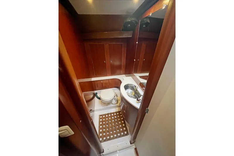 Slide: The Image of 1979 Amel Mango yacht bathroom with wooden cabinets and compact sink. - 27