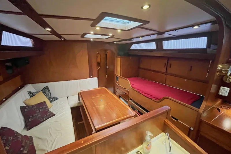 Slide: The Image of Interior of 1979 Amel Mango sailboat with cozy seating and wooden finishes. - 29