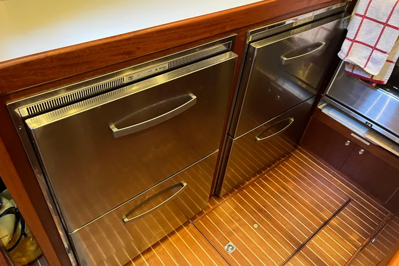Slide: The Image of Stainless steel kitchen drawers on a 1979 Amel Mango yacht with wooden flooring. - 33
